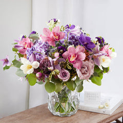 Bouquet of Purple Hydrangea, Cymbidium Orchid, White Tulip, Clematis, Eryngium Planum, Ocean Song Rose, and Lavender Spray Rose with Silver and Pittosporum greeneries.