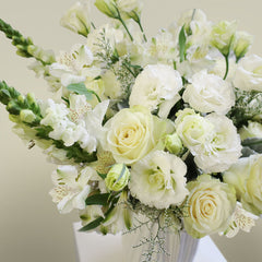 Bundle of Vendela Roses, Alstroemeria Whistler, Caspia, White Lisianthus, White Aster, Bupleurum and snapdragons with Dusty Miller greeneries.