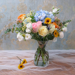 Bundle of Roses, Lisianthus, Pomp Daisies, and Blue Hydrangeas with Eucalyptus greeneries.