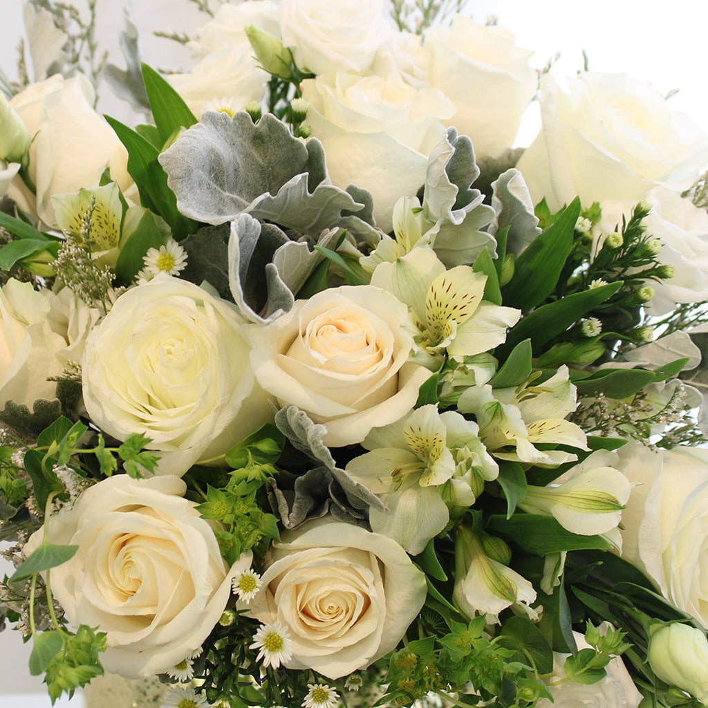Bundle of Vendela Roses, Alstroemeria Whistler, Caspia, White Lisianthus, White Aster, and Bupleurum with Dusty Miller greeneries.