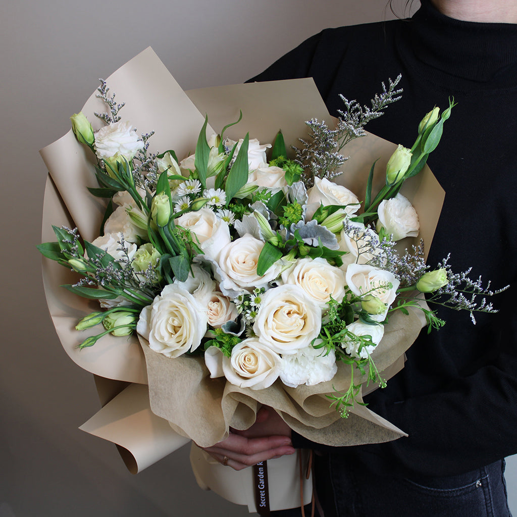Bundle of Vendela Roses, Alstroemeria Whistler, Caspia, White Lisianthus, White Aster, and Bupleurum with Dusty Miller greeneries.