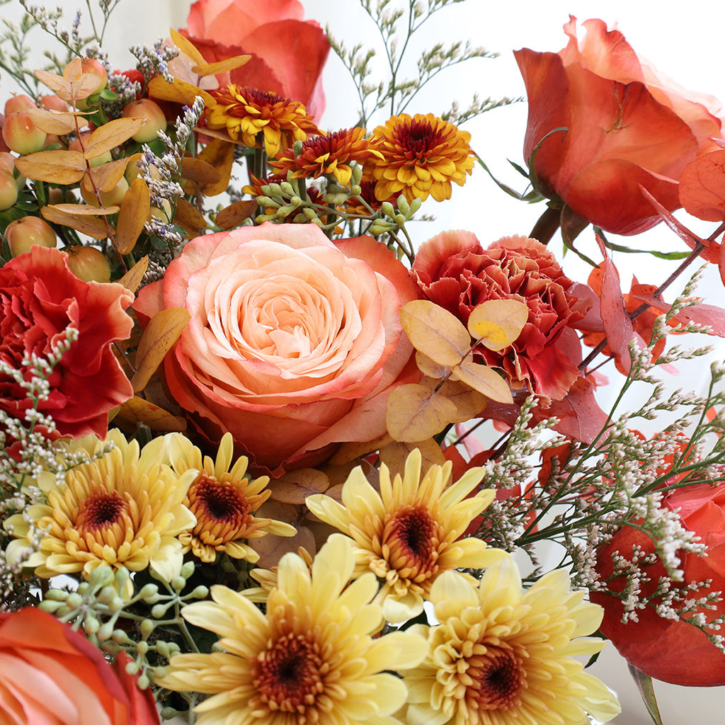 Bundle of Kahala Roses, Wax Flowers, Caspia, Pompoms and Specialty Carnations with Seeded and Rainbow Eucalyptus greeneries.