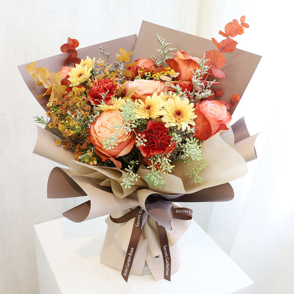 Bundle of Kahala Roses, Wax Flowers, Caspia, Pompoms and Specialty Carnations with Seeded and Rainbow Eucalyptus greeneries.