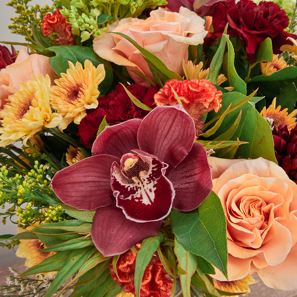 Bouquet of Green Hydrangeas, Phoenix Roses, Cymbidiums, Celosia, Burgundy Mums, Pompoms, Solidago, and Red Carnations with Lemon Leave greeneries.