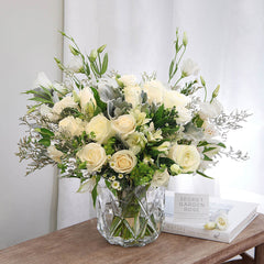 Bundle of Vendela Roses, Alstroemeria Whistler, Caspia, White Lisianthus, White Aster, and Bupleurum with Dusty Miller greeneries.